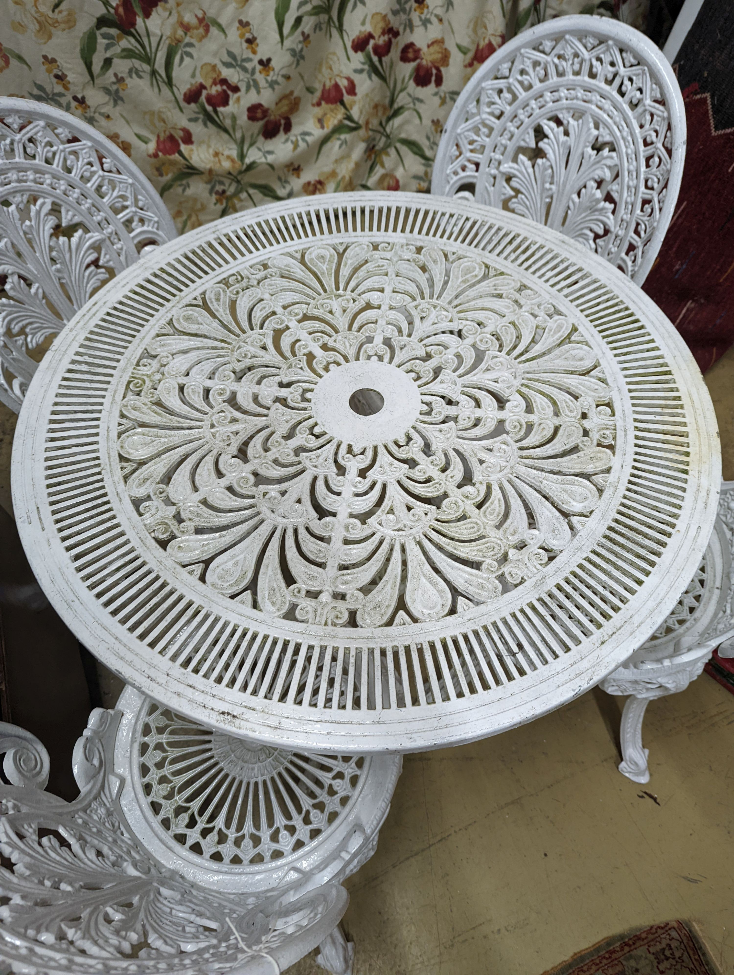 A Victorian style painted aluminium circular garden table, diameter 80cm, height 70cm and four chairs